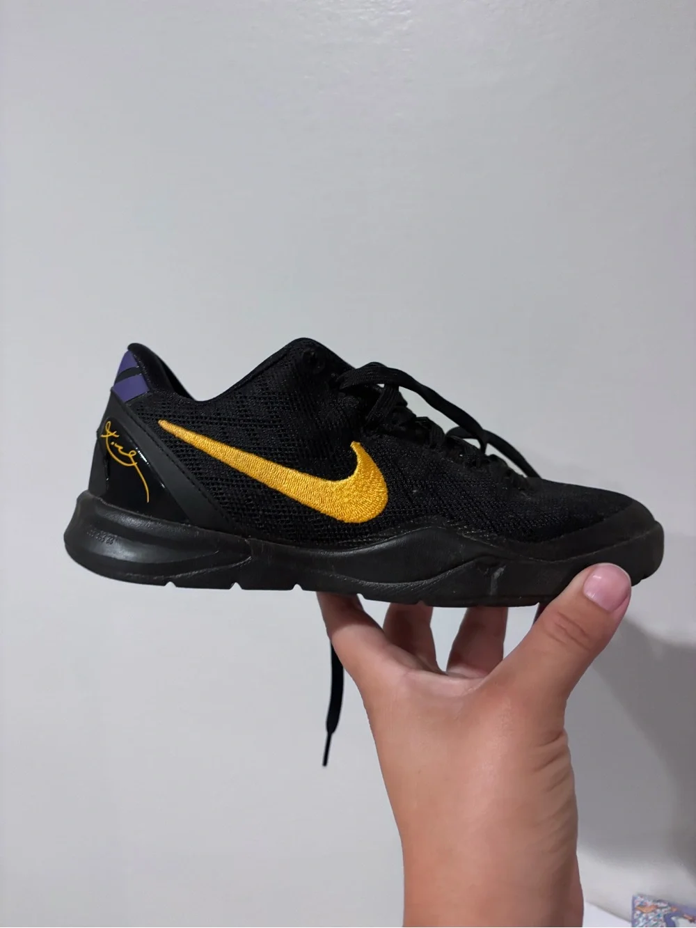 Nike Kids Black Sneakers with Gold Swoosh and Purple Heel